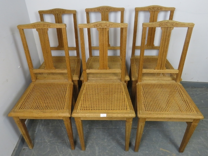 A set of six turn of the century light oak Swiss provincial dining chairs, with reeded and carved