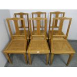 A set of six turn of the century light oak Swiss provincial dining chairs, with reeded and carved