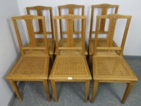 A set of six turn of the century light oak Swiss provincial dining chairs, with reeded and carved