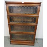 A vintage mahogany Globe-Wernicke stacking bookcase of four graduated sections, the glazed doors