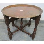 A 19th century Arts & Crafts copper tray table by Hugh Wallis, on a turned and block folding oak