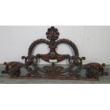 A well carved 19th century mahogany cornice depicting a laurel wreath amidst acanthus scrolls and