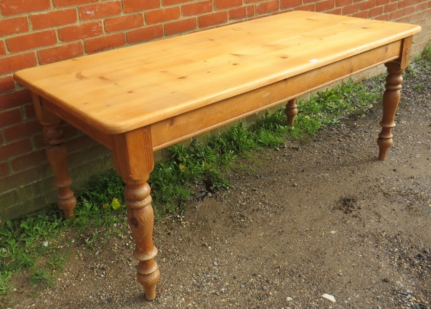 A vintage stripped pine country kitchen table, on baluster turned supports. Condition report: - Image 2 of 2