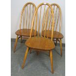 Three mid-century blond elm and beech Windsor Quaker dining chairs by Ercol, on canted supports with