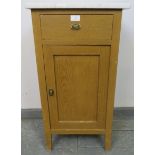 An antique Continental light oak marble topped bedside cabinet, with single drawer and cupboard