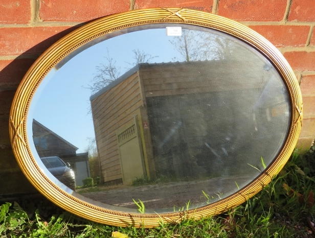 A vintage oval bevelled wall mirror with beaded edging, in a gilt gesso frame. With fixings for - Image 2 of 2