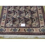 A late 20th century wool rug with a repeat pattern to central field, blue/cream. 200cm x 121cm. Very