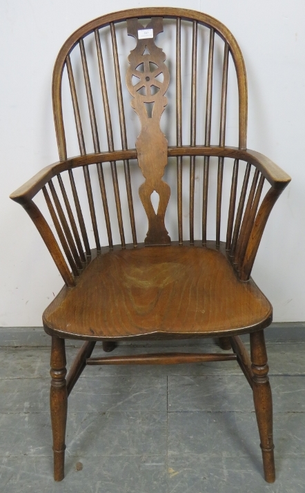 A 19th century oak and elm Windsor wheelback chair, on turned canted supports with an ‘H’ stretcher.