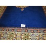 A Moroccan late 20th century wool carpet, central cream motif on a deep blue ground and cream