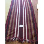 A mid - late 20th century Afghan rug/runner, red/brown, black and white stripe. 310cm x 94cm.