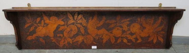 An Arts & Crafts stained pine wall hanging shelf, with pokerwork frieze depicting cherubs and fruit.