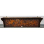 An Arts & Crafts stained pine wall hanging shelf, with pokerwork frieze depicting cherubs and fruit.