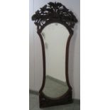A Victorian mahogany dressing mirror, the very ornate carved and pierced surround depicting entwined