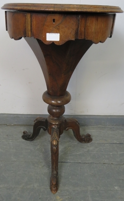 A Victorian rosewood trumpet/work table, the circular lid opening onto an array of lidded