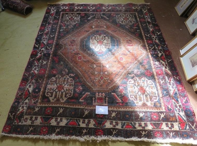 An early 20th century Persian rug (hand made in Iran). Central diamond pattern on fawn ground with 4