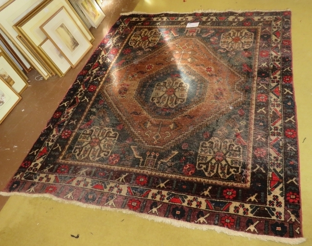 An early 20th century Persian rug (hand made in Iran). Central diamond pattern on fawn ground with 4 - Image 2 of 3