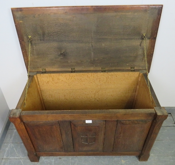 An Arts & Crafts oak coffer with fielded panels to all four sides and a relief carved shield to - Image 3 of 3