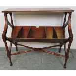 An Edwardian mahogany book trough, having five divided compartments, on faux bamboo tapering