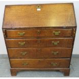 An 18th century oak bureau of small proportions, the fall front opening onto a fitted interior