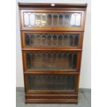 A vintage mahogany Globe-Wernicke stacking bookcase of four graduated sections, the glazed doors
