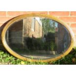 A vintage oval bevelled wall mirror with beaded edging, in a gilt gesso frame. With fixings for