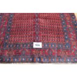 North West Persian Senneh rug, central repeat pattern divided by blue motif on burgundy ground, very