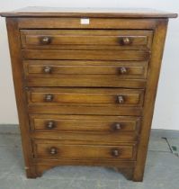 A vintage period style oak chest of five graduated drawers, with turned handles, on bracket feet.