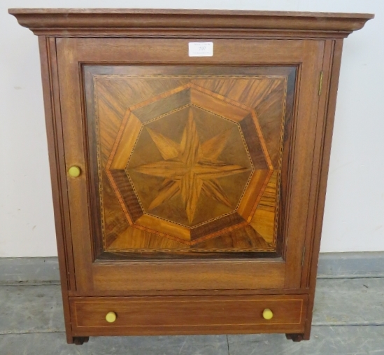 A vintage wall hanging cabinet, the panelled door featuring starburst parquetry inlay with one