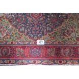 A good Persian Tabriz carpet, large central floral motif on a pale green field surrounded by a