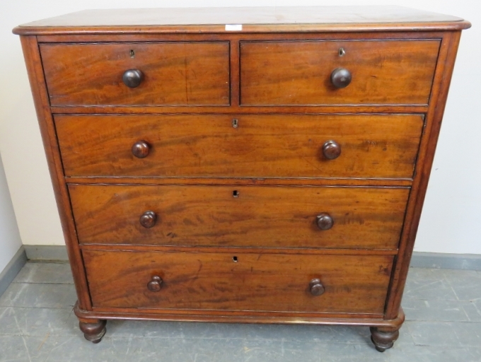A Victorian mahogany straight-front chest of two short over three long cock-beaded drawers, on