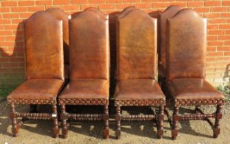 Eight antique style high back dining chairs, upholstered in distressed brown leather with large