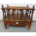 A Victorian figured walnut serpentine front Canterbury, featuring carved and pierced uprights and