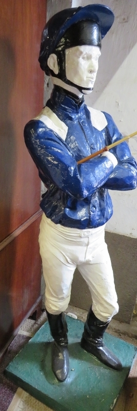 A life-size painted plaster figure of a jockey in racing colours, with riding crop, on a plinth - Image 3 of 5