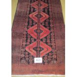 North East Persian Meshed Belouch rug. Central repeat pattern on black ground with a wide slightly