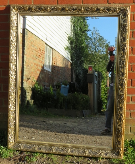 A large rectangular gilt framed bevelled wall mirror with moulded surround in the Art Nouveau taste.