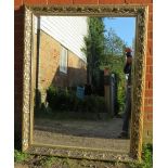 A large rectangular gilt framed bevelled wall mirror with moulded surround in the Art Nouveau taste.