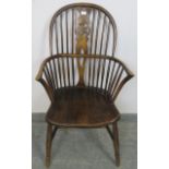 A Georgian elm wheelback Windsor armchair, on turned supports with an ‘H’ stretcher. Condition