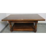 A vintage heavy oak two-tier rectangular coffee table, on baluster turned supports with bun feet.
