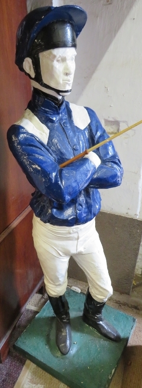 A life-size painted plaster figure of a jockey in racing colours, with riding crop, on a plinth - Image 2 of 5