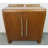 An Art Deco walnut crossbanded sideboard featuring stepped sides, housing two loose shelves, on