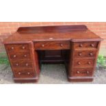 A Victorian mahogany reverse breakfront kneehole desk, with rear gallery, housing a configuration of
