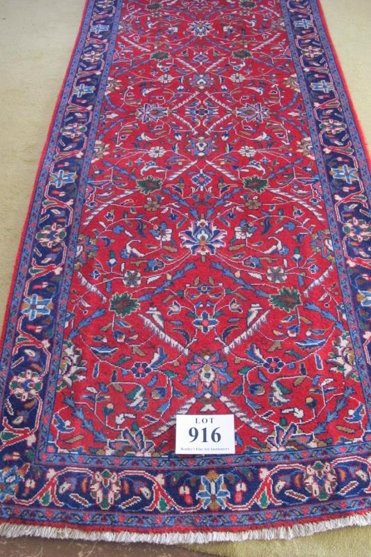 North West Persian Sarouk runner. Central foliage on claret ground and repeat blue border. Good