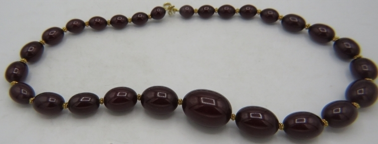 A vintage graduated faux cherry amber necklace, cleaned, re-strung and with vermeil spacers.