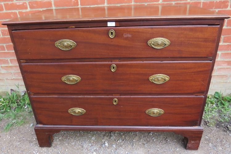 A George III mahogany straight front chest of three long graduated oak-lined drawers with pressed