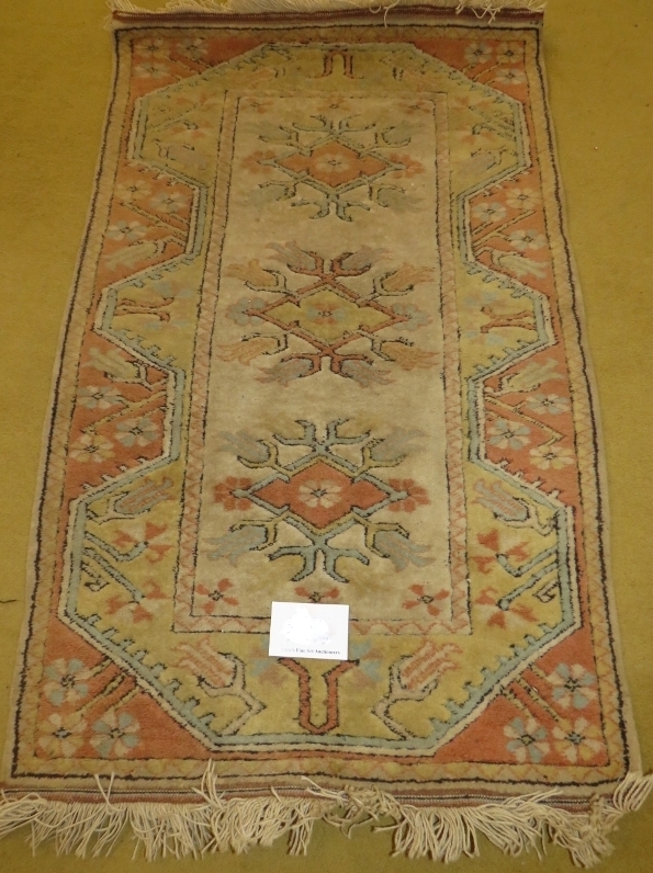 A late 20th century wool rug. Pastel shades. 135cm x 82cm. In good condition.