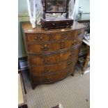 A reproduction mahogany finished bow front chest of drawers crossbanded top upper drawer, having