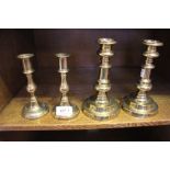 TWO PAIRS OF BRASS CANDLESTICKS