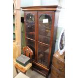 A mahogany cased freestanding two door set of adjustable shelves