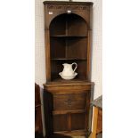 A reproduction oak finished small-sized freestanding corner cupboard with open upper section and