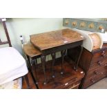 A REPRODUCTION WALNUT COLOURED NEST OF THREE TABLES